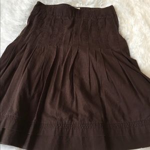 Brown pleated fitted to flaired skirt